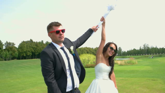 Smiling-wedding-couple-in-sunglasses.