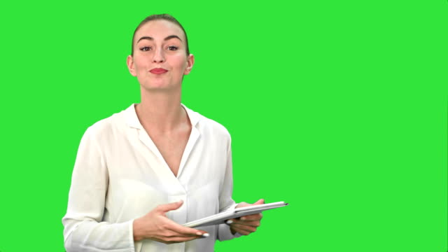 Mujeres-jóvenes-con-tableta-digital-que-presenta-el-proyecto-en-una-pantalla-verde-Chroma-Key