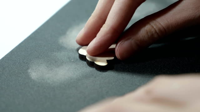 An-artist-grinds-wooden-craft-on-sandpaper
