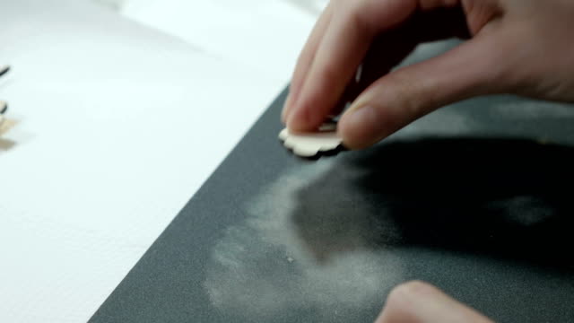 An-artist-grinds-wooden-craft-on-sandpaper