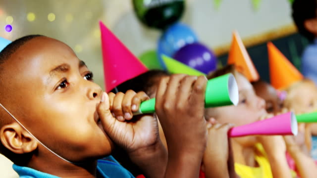 Kids-blowing-party-horns-during-birthday-party-4k