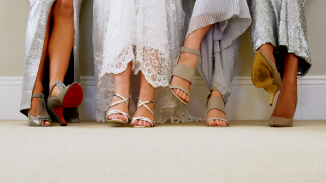 Bride-and-bridesmaids-show-off-their-shoes-4K-4k