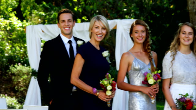 Happy-young-bride-and-groom-pose-with-family-and-friends-4K-4k