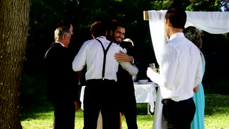 Happy-groom-hugging-guests-4K-4k