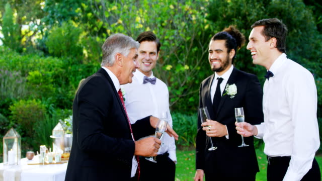 Father-of-the-Bride-having-champagne-with-groom-and-guest-4K-4k