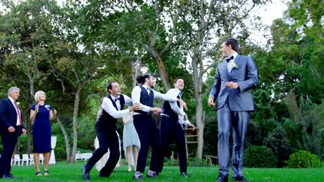 Garter-toss-by-happy-groom-and-groomsmen-catch-it-4K-4k