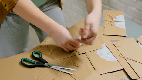 2-shots.-Two-professional-women-decorators-making-envelopes-at-workshop
