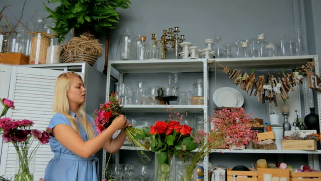 Professional-florist-making-beautiful-bouquet-at-flower-store