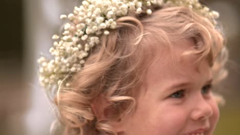 Portrait-of-little-flower-girl-smiling-on-wedding-day