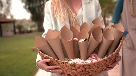 Close-up-of-young-woman-holding-flower-basket-for-wedding-celebrations
