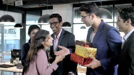 A-cheerful-and-happy-group-of-employees-from-startup-firm-celebrating-birthday-by-giving-out-gifts