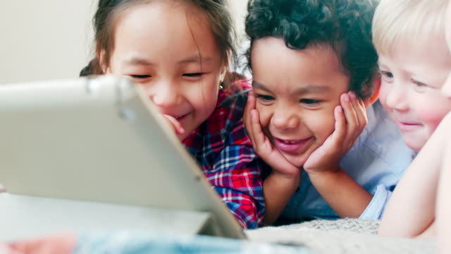 Multiethnic-Kids-Watching-Cartoon-on-Tablet-and-Laughing