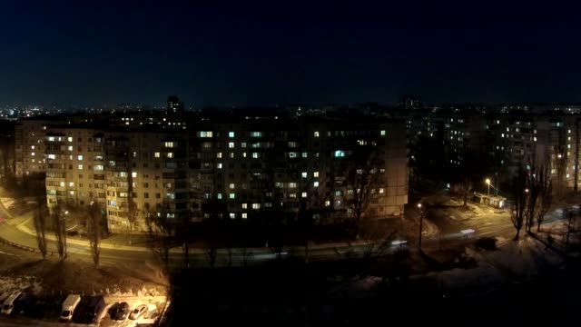 Timelapse-of-the-windows-of-a-multistory-apartment-building-during-sunset