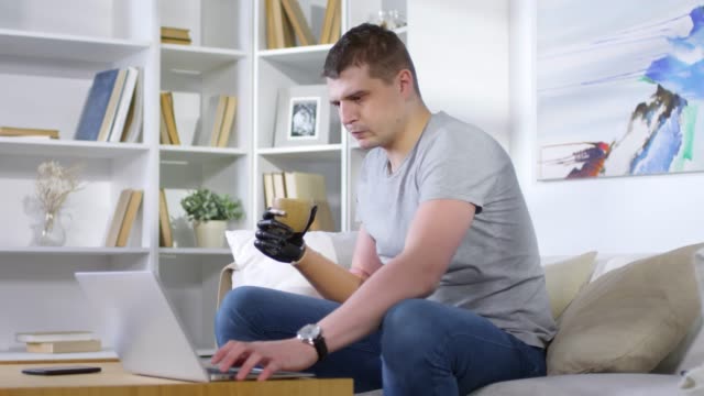 Man-with-Artificial-Arm-Working-from-Home