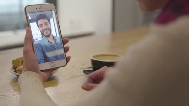 Video-Call.-Close-Up-Hand-With-Video-Chat-On-Mobile-Phone-Screen
