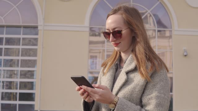 Beautiful-woman-using-smartphone-outside
