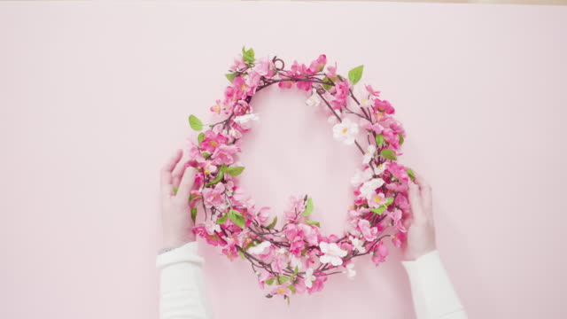 pink-silk-flower-wreath-on-a-pink-background.