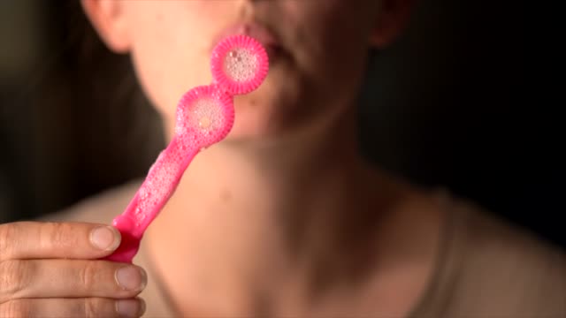 closeup-macro-real-time-lips-blowing-bubbles-at-camera