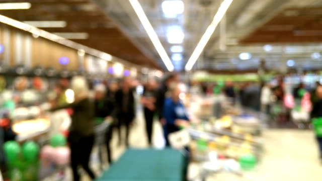 Abstract-blurred-motion-of-customers-in-food-and-grocery-store,-and-defocused-interior.