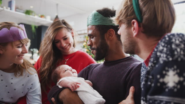 Gay-Male-Couple-With-Adopted-Baby-Daughter-Celebrating-First-Christmas-With-Friends