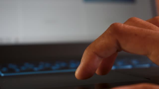 Close-up-shot-of-hands-of-a-female-using-laptop-via-touchpad