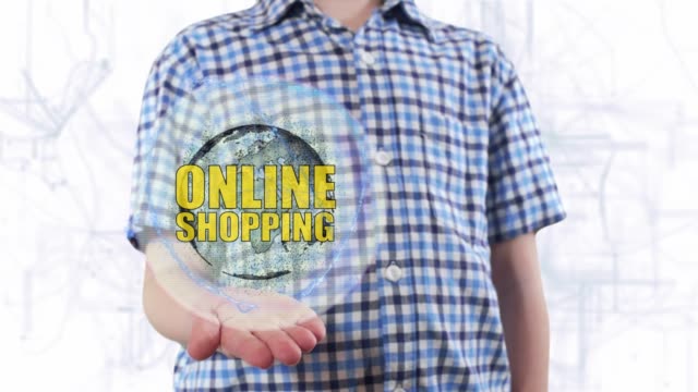 Young-man-shows-a-hologram-of-the-planet-Earth-and-text-Online-shopping