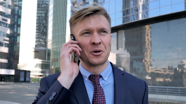 Businessman-Discussing-on-Phone,-Standing-Outside-Office