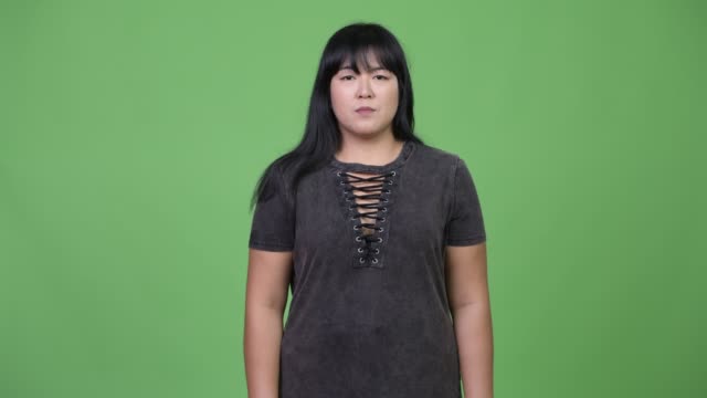 Happy-overweight-Asian-woman-giving-handshake