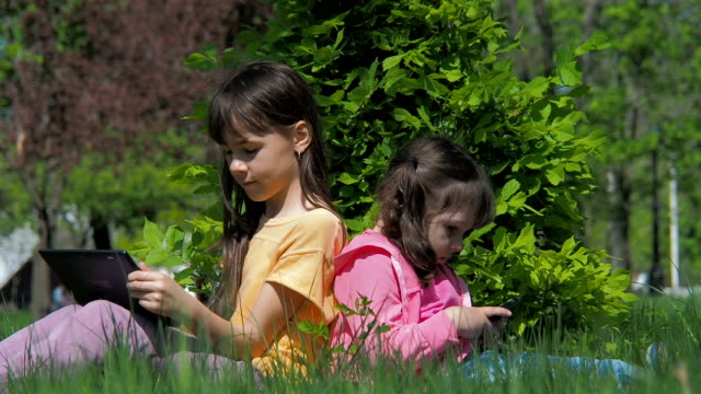 Children-with-gadgets-on-nature.