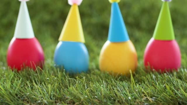 easter-eggs-in-party-caps-on-artificial-grass