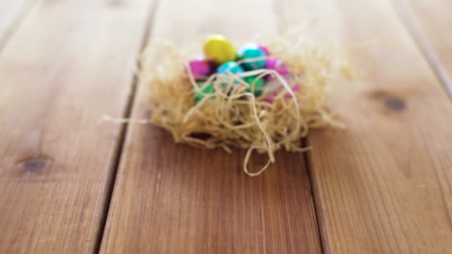 chocolate-easter-eggs-in-straw-nest-on-table