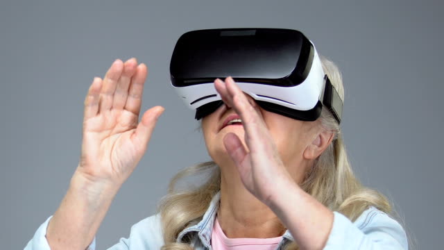 Mature-woman-wearing-virtual-reality-headset,-entertainment-device,-innovation