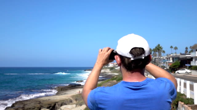 Man-recording-video-of-oceanside-in-California-in-slow-motion-250fps