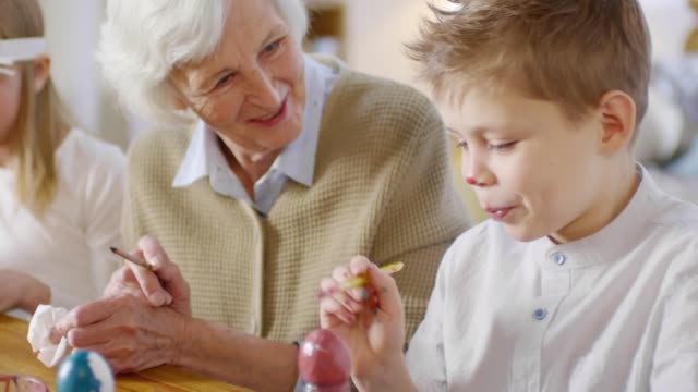 Grandmother-and-Grandchildren-Painting-Eggs-for-Easter