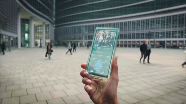 Slow-motion-of-a-business-woman-hand-using-a-futuristic-glass-cell-phone-with-the-latest-advanced-augmented-reality-holographic-technology-to-make-video-call-to-her-colleagues
