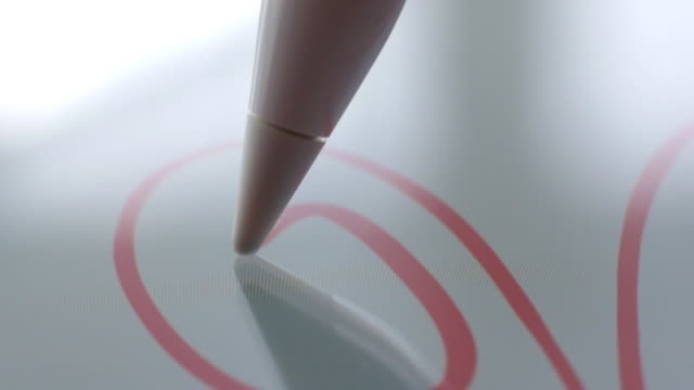 Macro-Follow-Shot-of-an-artist-hand-drawing-on-a-digital-tablet-with-pencil.-Pencil-is-Connected-to-the-Camera.-Gripped-Shot.
