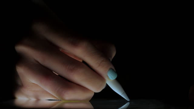 Nahaufnahme-der-Hand-des-Künstlers-Zeichnung-auf-einem-digitalen-Tablet-mit-Bleistift-in-dunklen-Raum-ohne-Licht.