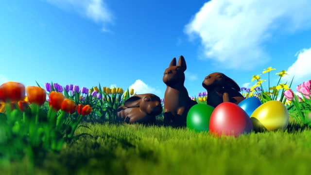 Easter-Eggs-and-Chocolate-Bunnies-on-green-meadow-with-colorful-tulips