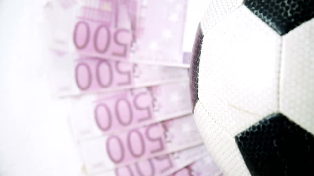 Football-and-dollar-on-white-background-4k