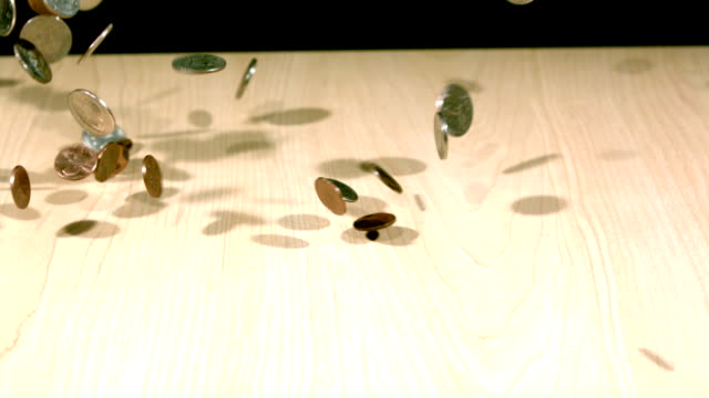 slow-motion-coins-bouncing-on-table