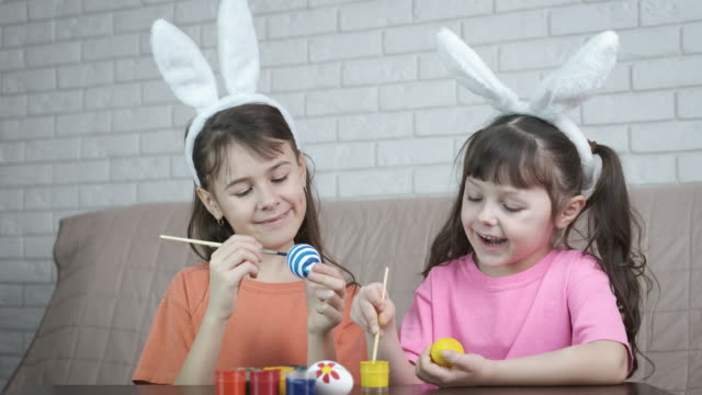 Easter.-Children-paint-eggs.