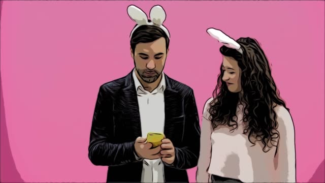 Young-lovers-couple-on-pink-background.-With-hungry-ears-on-the-head.-During-this-Easter-photo,-I-made-sephi-on-my-phone-and-looked-at-them-laughing.-Easter-.Animation.