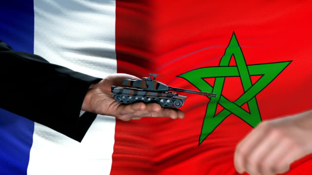 France-and-Morocco-officials-exchanging-tank-for-money,-flag-background,-deal