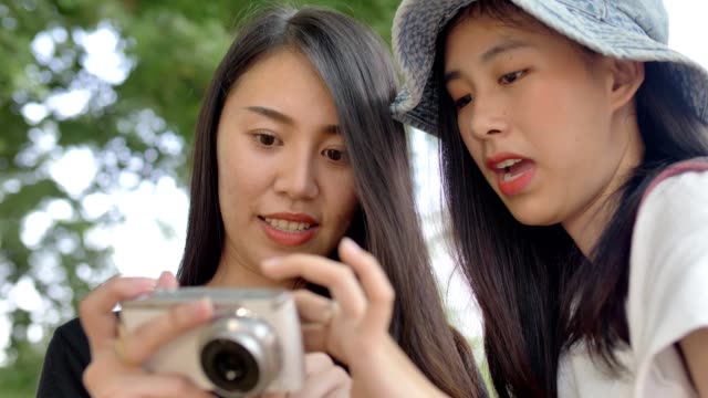 Happy-Young-Asian-girls-Smiling-And-Taking-Selfie-Photo-To-The-Camera