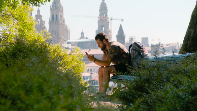 Tourist-Man-On-Pilgrimage-At-Santiago-de-Compostela-With-Smartphone