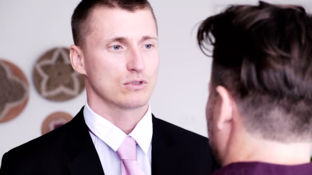 Hombre-gay-ayudar-a-su-pareja-a-poner-corbata-para-la-entrevista-de-trabajo.-Asegúrate-de-que-se-vista-mejor.