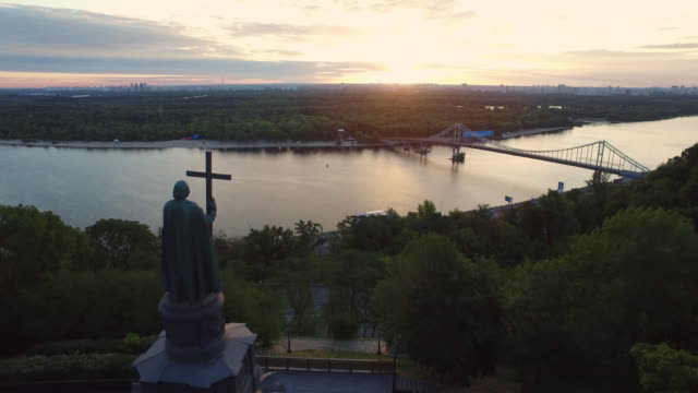 Aerial-view-monument-Prince-Vladimir-with-cross-on-evening-Kiev-city-landscape