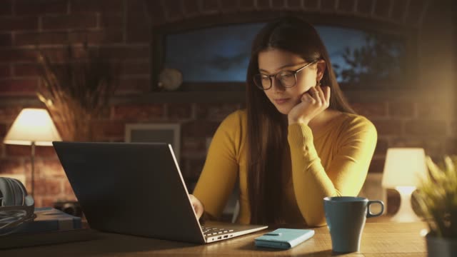Smiling-woman-chatting-with-her-laptop