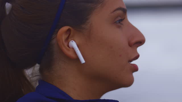 Slow-motion-close-up-of-young-woman-face-running-with-earphones