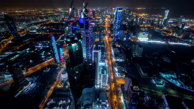 Skyline-with-Skyscrapers-night-timelapse-in-Kuwait-City-downtown-illuminated-at-dusk.-Kuwait-City,-Middle-East